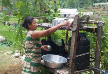 Sushila Syangtan, EHFP member, drying utensils on dish drying rack at Ambhanjyang