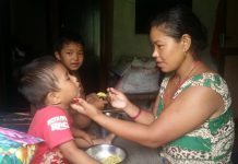 Sushila Syangtan, EHFP member feeding nutritious food to her baby at Ambhanjyang-7